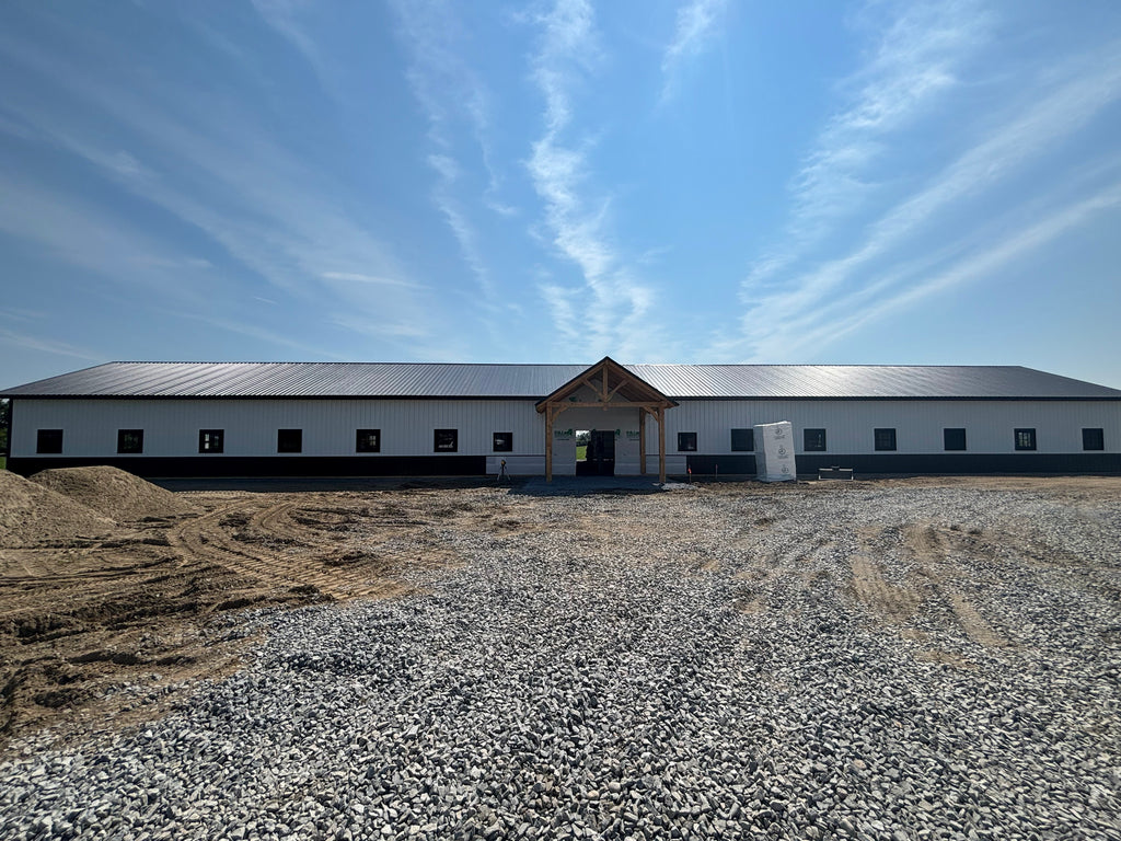 Large industrial building with a flat roof under a clear blue sky.